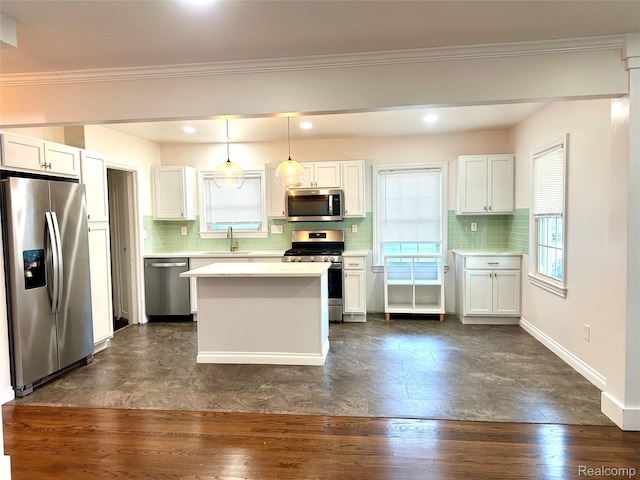 20979 Audette St, Dearborn, MI 48124 - kitchen with stainless steel appliances, light countertops, tasteful backsplash, white cabinetry, and crown molding