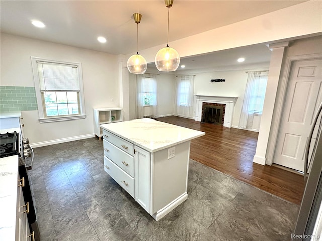 20979 Audette St, Dearborn, MI 48124 - kitchen featuring healthy amount of natural light, a brick fireplace, a center island, decorative light fixtures, and recessed lighting