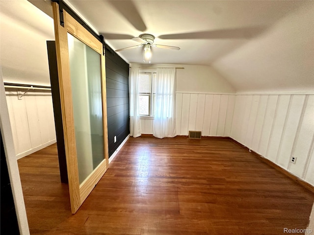 20979 Audette St, Dearborn, MI 48124 - additional living space featuring a ceiling fan, wood finished floors, a barn door, vaulted ceiling, and a decorative wall