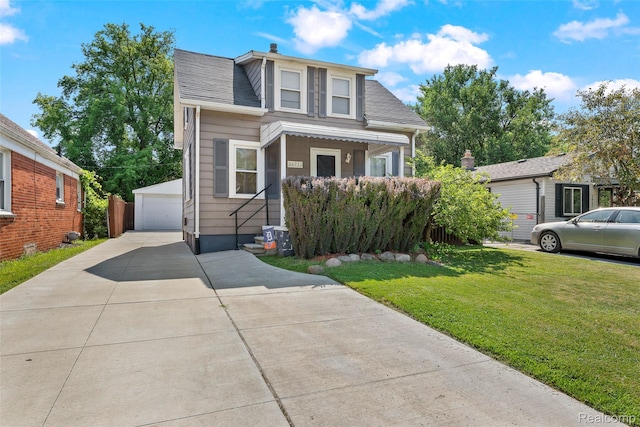 26752 Blackmar Ave, Warren, MI 48091 - bungalow-style home with an outbuilding, a detached garage, a front yard, and a shingled roof
