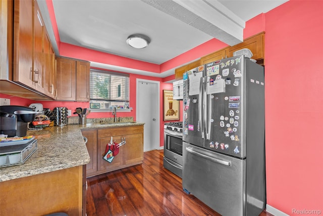 26752 Blackmar Ave, Warren, MI 48091 - kitchen featuring appliances with stainless steel finishes, brown cabinets, dark wood-style floors, and light stone countertops
