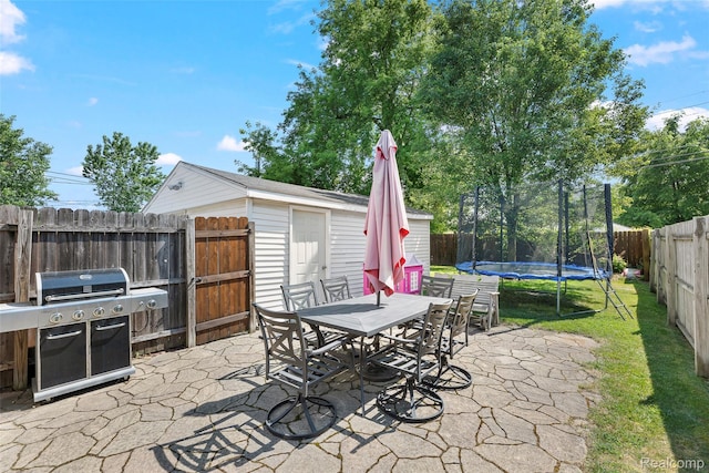 26752 Blackmar Ave, Warren, MI 48091 - fenced backyard featuring a grill, a patio area, a trampoline, outdoor dining space, and a storage shed