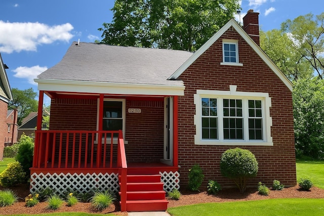 5260 Coplin St, Detroit, MI 48213 - view of front of property with a porch, brick siding, and a chimney
