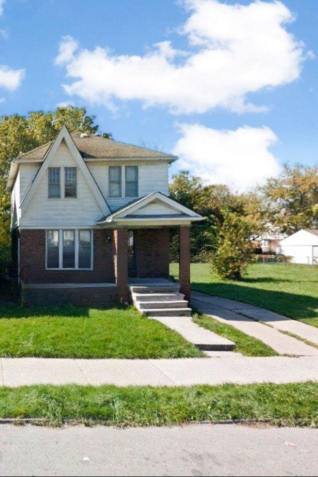 5081 Barham St, Detroit, MI 48224 - view of front of home featuring a porch, a front yard, and brick siding