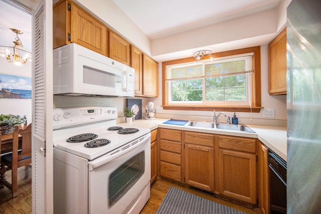 1507 Dicken Dr, Ann Arbor, MI 48103 - kitchen featuring white appliances, light wood-style floors, light countertops, and a chandelier