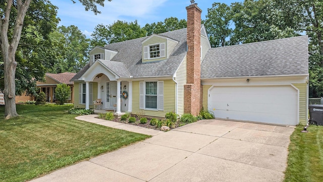 1507 Dicken Dr, Ann Arbor, MI 48103 - cape cod home featuring roof with shingles, an attached garage, a chimney, concrete driveway, and a front yard