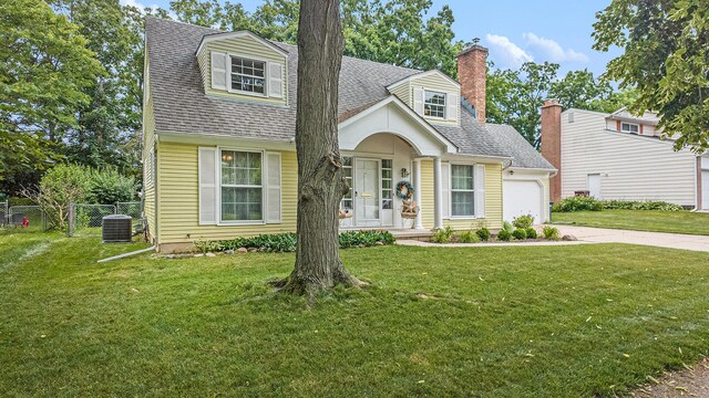 1507 Dicken Dr, Ann Arbor, MI 48103 - view of front of house with driveway, a shingled roof, a garage, a chimney, and a porch
