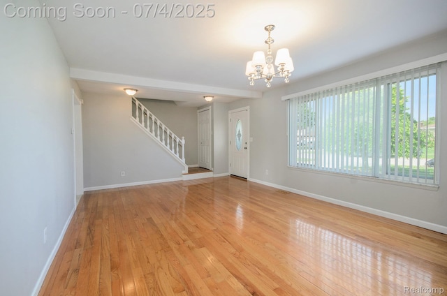 37718 Douglas Ct, Sterling Heights, MI 48310 - foyer entrance featuring a chandelier, light wood-style flooring, and stairs