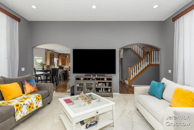 5322 S Silverstone Dr NE, Comstock Park, MI 49321 - living area featuring arched walkways, recessed lighting, stairway, and wood finished floors