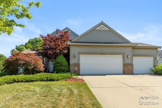5322 S Silverstone Dr NE, Comstock Park, MI 49321 - view of front of property featuring brick siding, an attached garage, concrete driveway, and a front yard