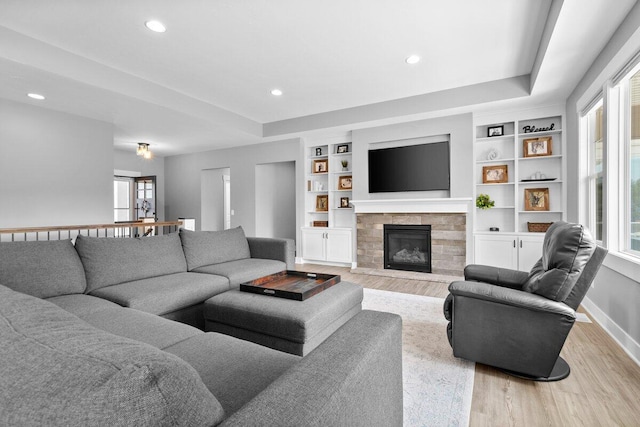 1560 Marksbury Ct, Byron Center, MI 49315 - living area featuring light wood-style floors, a stone fireplace, recessed lighting, and built in features
