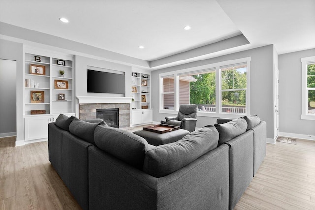 1560 Marksbury Ct, Byron Center, MI 49315 - living area with light wood finished floors, a fireplace, recessed lighting, and built in features