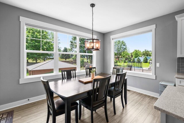 1560 Marksbury Ct, Byron Center, MI 49315 - dining space featuring a chandelier and light wood-style flooring