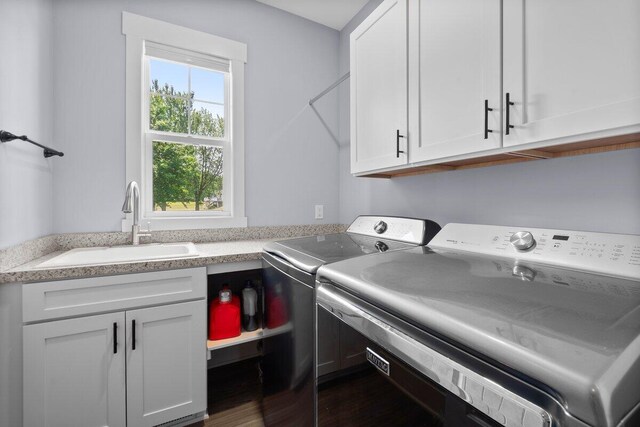 1560 Marksbury Ct, Byron Center, MI 49315 - washroom featuring separate washer and dryer, cabinet space, and dark wood-type flooring