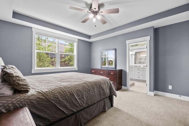 1560 Marksbury Ct, Byron Center, MI 49315 - bedroom with light carpet, multiple windows, connected bathroom, and a tray ceiling