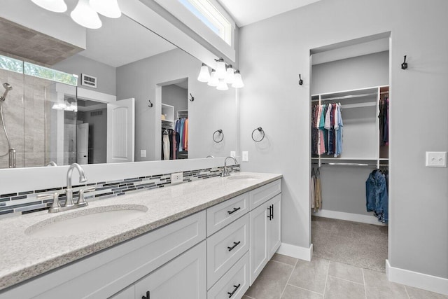 1560 Marksbury Ct, Byron Center, MI 49315 - bathroom featuring double vanity, a spacious closet, healthy amount of natural light, and tile patterned floors