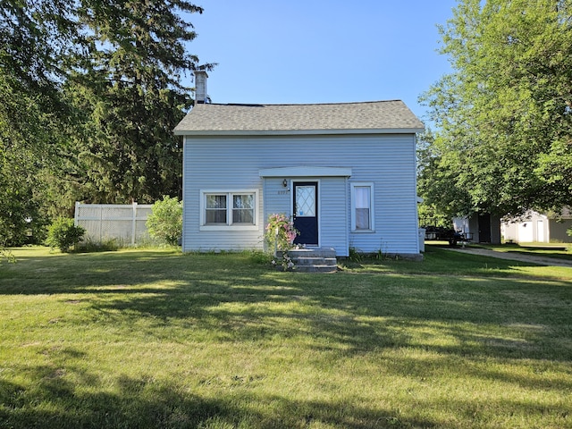 8991 W 1 Mile Rd, Hesperia, MI 49421 - rear view of house with a chimney and roof with shingles