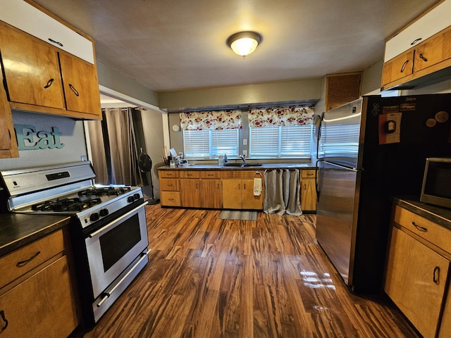 8991 W 1 Mile Rd, Hesperia, MI 49421 - kitchen with appliances with stainless steel finishes, brown cabinets, and dark countertops