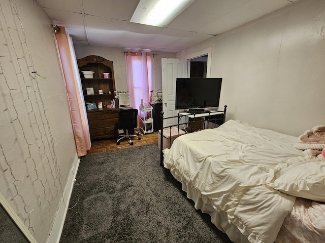 8991 W 1 Mile Rd, Hesperia, MI 49421 - bedroom featuring a paneled ceiling, an office area, and dark wood-style flooring