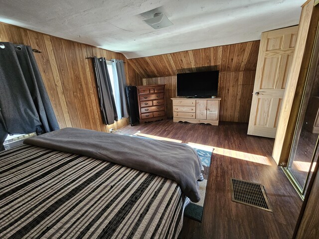 8991 W 1 Mile Rd, Hesperia, MI 49421 - bedroom featuring wood walls, vaulted ceiling, and dark wood-type flooring