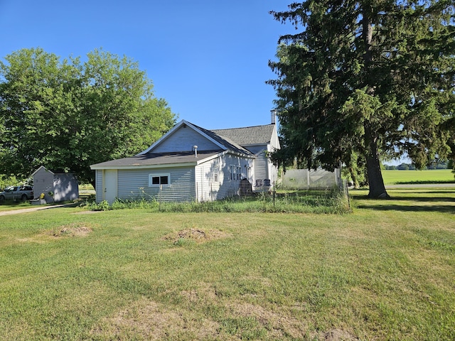 8991 W 1 Mile Rd, Hesperia, MI 49421 - view of side of property featuring a lawn and a shingled roof