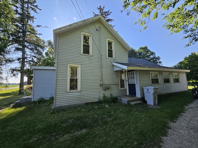 8991 W 1 Mile Rd, Hesperia, MI 49421 - rear view of house featuring a lawn