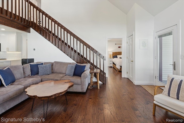 4294 N E Torch Lake Dr, Central Lake, MI 49622 - living area with high vaulted ceiling, stairs, and wood finished floors