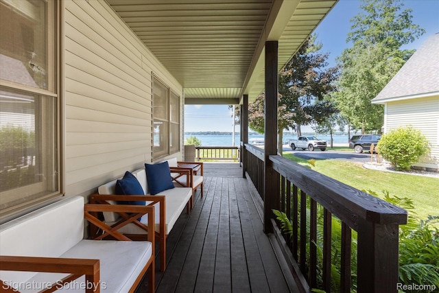 4294 N E Torch Lake Dr, Central Lake, MI 49622 - wooden porch featuring a water view and a yard