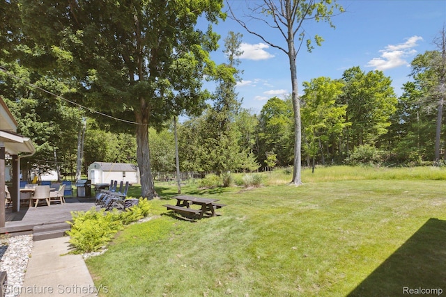 4294 N E Torch Lake Dr, Central Lake, MI 49622 - view of grassy yard with a wooden deck and a shed