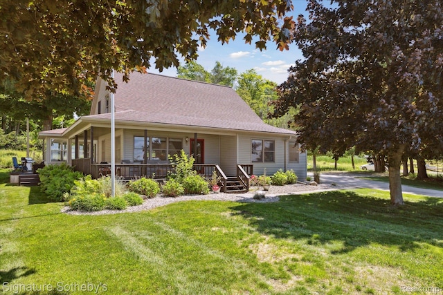 4294 N E Torch Lake Dr, Central Lake, MI 49622 - farmhouse with a front lawn, covered porch, and roof with shingles