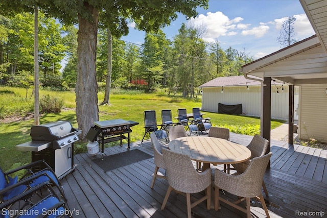4294 N E Torch Lake Dr, Central Lake, MI 49622 - wooden deck with a lawn, outdoor dining space, area for grilling, and view of wooded area