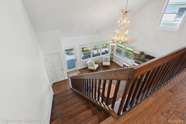 4294 N E Torch Lake Dr, Central Lake, MI 49622 - stairway featuring a chandelier, hardwood / wood-style floors, and high vaulted ceiling