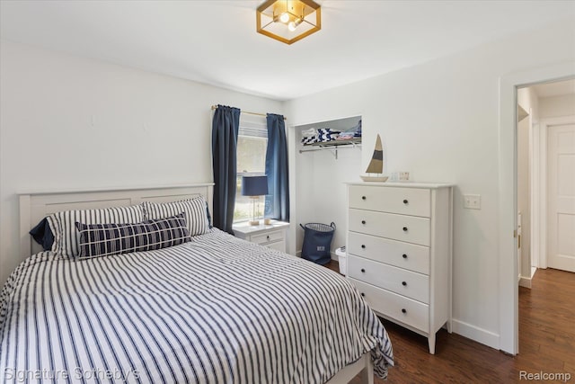 4294 N E Torch Lake Dr, Central Lake, MI 49622 - bedroom with dark wood-style floors and baseboards