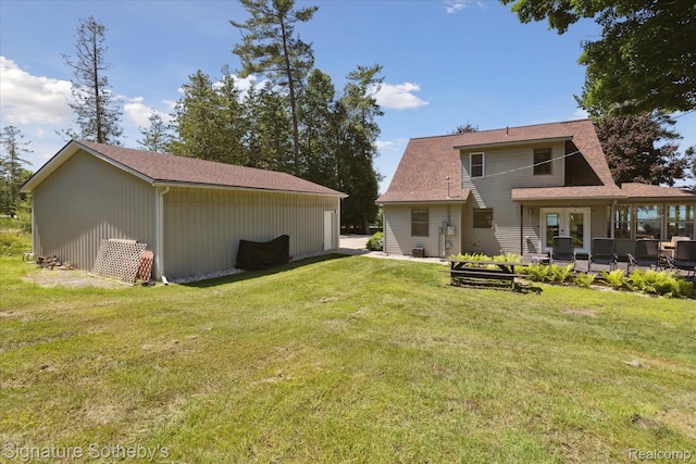 4294 N E Torch Lake Dr, Central Lake, MI 49622 - back of house featuring a lawn and a patio area