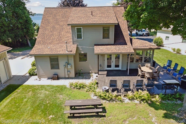 4294 N E Torch Lake Dr, Central Lake, MI 49622 - rear view of house featuring a wooden deck, a shingled roof, and a yard