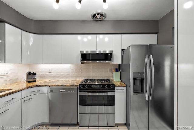 1982 Wickham St, Royal Oak, MI 48073 - kitchen with stainless steel appliances, white cabinetry, tasteful backsplash, and light stone counters
