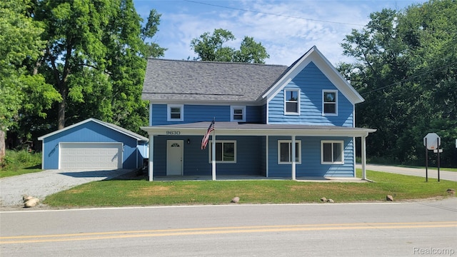 9630 Lambs Rd, Goodells, MI 48027 - view of front of home featuring an outbuilding, a detached garage, a front yard, covered porch, and roof with shingles