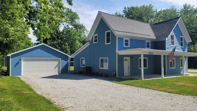 9630 Lambs Rd, Goodells, MI 48027 - view of front of home featuring a garage, an outbuilding, roof with shingles, and a front lawn