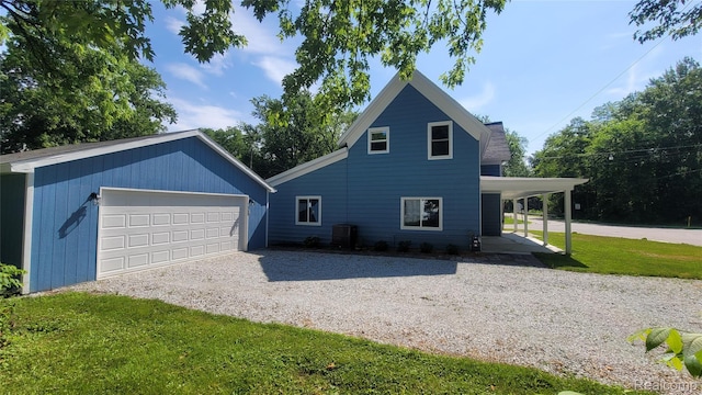 9630 Lambs Rd, Goodells, MI 48027 - view of home's exterior with a garage, a yard, and an outdoor structure