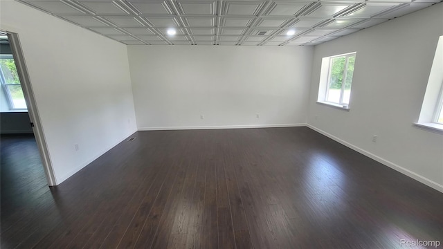 9630 Lambs Rd, Goodells, MI 48027 - empty room featuring dark wood-type flooring and an ornate ceiling