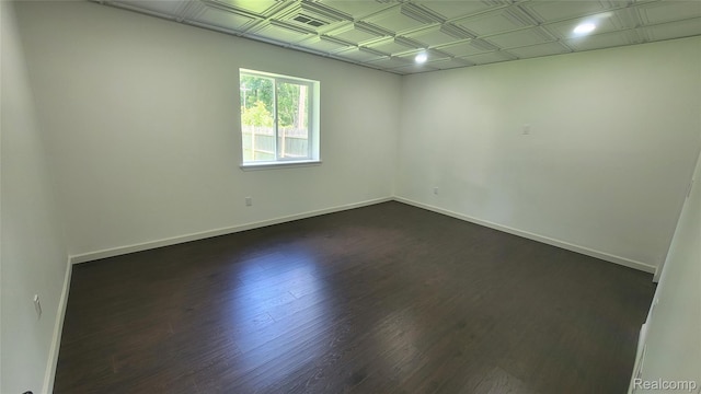 9630 Lambs Rd, Goodells, MI 48027 - unfurnished room featuring dark wood finished floors and an ornate ceiling