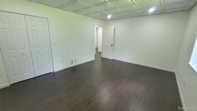 9630 Lambs Rd, Goodells, MI 48027 - unfurnished bedroom with dark wood-type flooring, a closet, an ornate ceiling, and recessed lighting