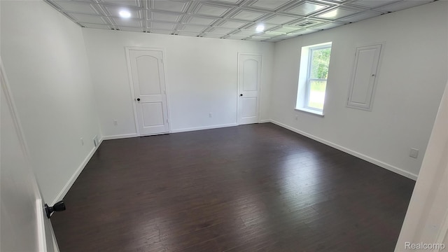 9630 Lambs Rd, Goodells, MI 48027 - unfurnished room with dark wood-type flooring, an ornate ceiling, and electric panel