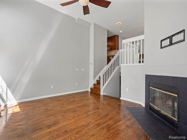 1524 Maryland Club Dr, Royal Oak, MI 48067 - unfurnished living room featuring stairway, ceiling fan, a tile fireplace, and wood finished floors