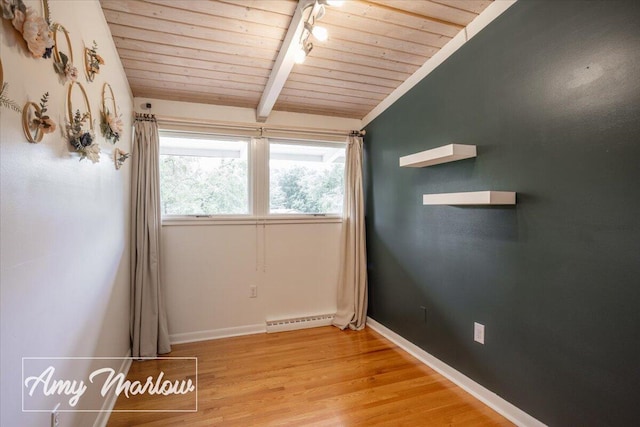 708 Magnolia Ct, Big Rapids, MI 49307 - empty room with wooden ceiling, light wood finished floors, and a baseboard radiator