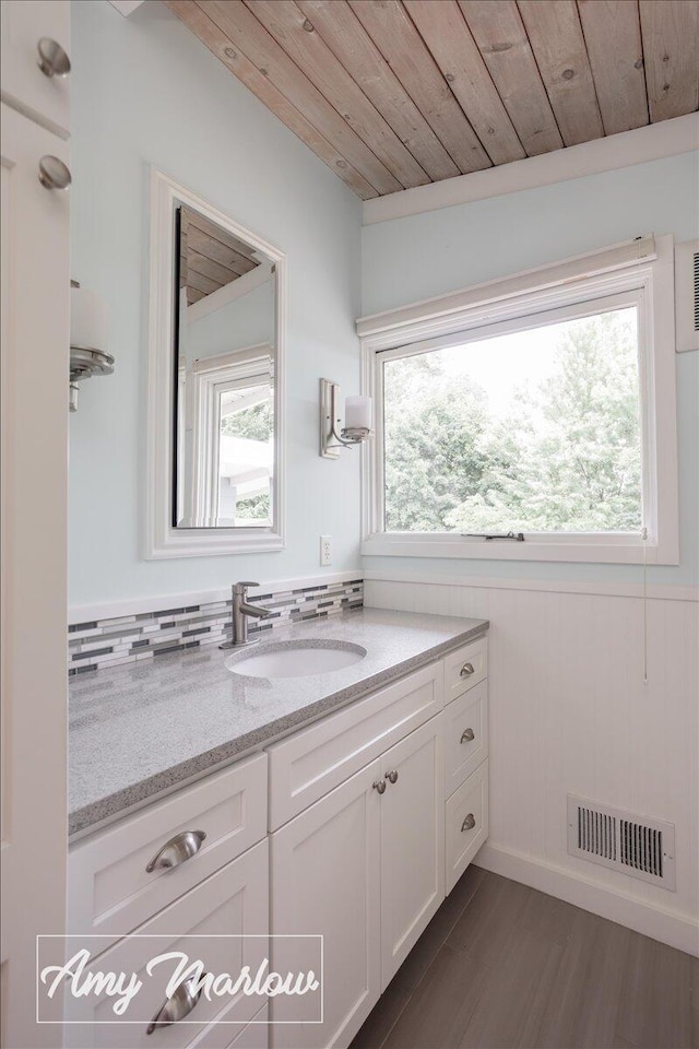 708 Magnolia Ct, Big Rapids, MI 49307 - bathroom with vanity, plenty of natural light, wood ceiling, and wood finished floors
