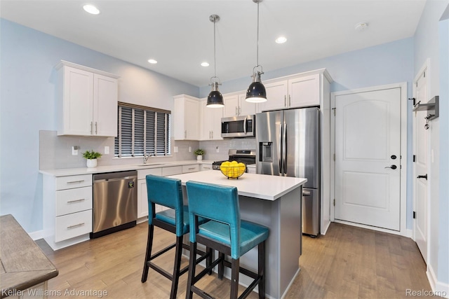 38 E Dallas Ave, Madison Heights, MI 48071 - kitchen with appliances with stainless steel finishes, light wood-type flooring, light countertops, white cabinetry, and recessed lighting