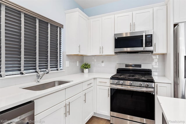 38 E Dallas Ave, Madison Heights, MI 48071 - kitchen featuring appliances with stainless steel finishes, light countertops, white cabinetry, and backsplash