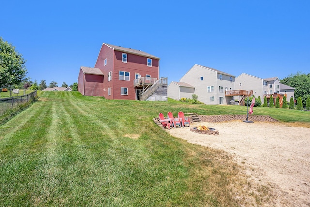 9330 Windward Dr, West Olive, MI 49460 - view of yard featuring a fire pit, stairway, and a wooden deck