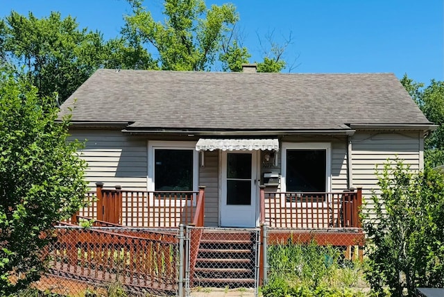 1079 Hurd Ave, Benton Harbor, MI 49022 - view of front of property featuring roof with shingles, a gate, and a chimney